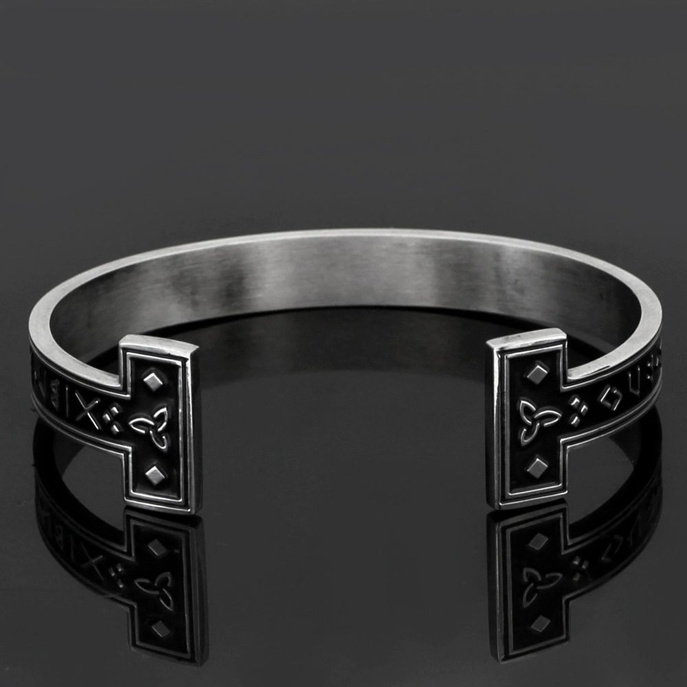 Silver cuff bracelet with Celtic knot pattern